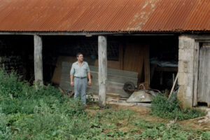 Peter Bowman in front of the barn before restoration